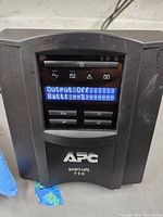 Front view of APC Smart-UPS 750 with LCD screen reading Output Off and battery charge indicator.