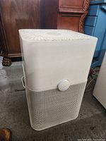Front view of the Blue air purifier with control knob and mesh lower section.