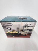 Front view of the Brentwood 6-inch Electric Skillet box showing product image and basic features including non-stick surface and 32 oz capacity.