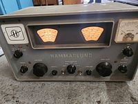 Front view of Hammarlund radio with dual tuning meters, controls, and current level meter.