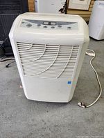 Front view of a white Maytag dehumidifier unit showing the vented front panel and top control panel.