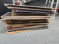 Stack of vinyl record album covers showing the thickness and condition of the lot