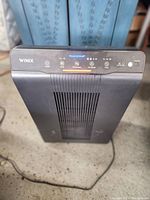 Front view of the black Winix PlasmaWave air purifier showing control panel and air vent.