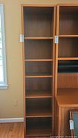 Photo of one wooden bookcase showing full height and multiple adjustable shelves.