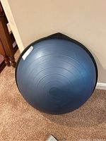 Blue Bosu ball top view showing concentric circles on inflatable rubber dome hemisphere.