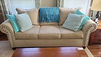 Front view of sofa with throw and pillows