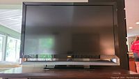 Front view of the 55 inch Vizio flat screen TV showing the screen and black frame.