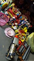 Overview image featuring a variety of toddler toys including New Bright trains, pull toys, small figures, and cars all grouped on the floor.