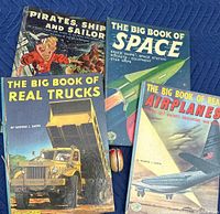 Photo showing four vintage children's books with colorful illustrated covers and a wooden yo-yo in the middle on a blue moving blanket.