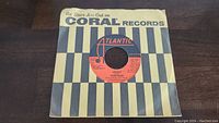 Front side of the record sleeve showing a striped Coral Records design with Atlantic Records label visible through the center hole.