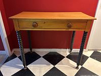 Front view showing the pine tabletop with one drawer and spiraled turned legs with original paint.