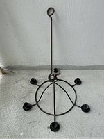 Full view of the wrought iron 6-arm hanging candlelight fixture showing its circular base and six candle holders.