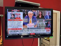 32 inch Toshiba flat screen TV displaying a news channel on the screen, shows active display and Toshiba logo on bezel.