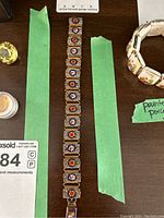 Full length photo of the 8.5 inch mosaic bracelet showing all linked floral segments.