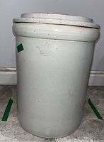 Full body image of the stoneware crock showing its cylindrical shape and light gray glaze with the crown mark