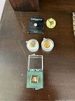 Overview of all stones and pin on a dark wood surface