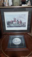 Two framed horse pictures displayed, one large square titled 'The Meet' and one smaller oval print below it.