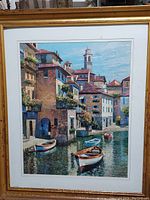 Full view of framed artwork showing canal scene with boats and buildings