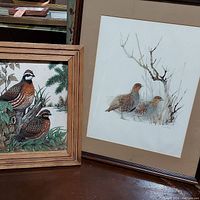 Photo of two framed quail bird artworks displayed side by side on a table, showing fabric print on left and watercolor on right.