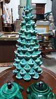 Frontal photo of the vintage light green ceramic Christmas tree showing colorful attached bulbs and the two ceramic bases placed in front