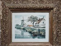 Frontal view showing the entire framed windmill print with ornate wooden frame and detailed carving, including gold overlay and burgundy undertones.