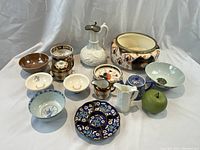 All 13 ceramic pieces displayed together with green apple size reference