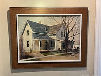 Full view of framed watercolor painting showing house and surrounding landscape