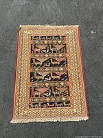 Full view of the handmade Afghan Turkmen rug laid out flat showing pattern and border details.