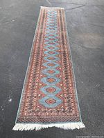 Full length view of rug runner on asphalt surface