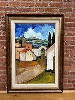 Full view of framed painting against brick wall