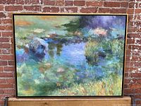 Full front view of oil painting in black frame against brick wall