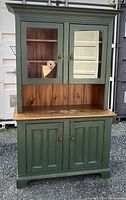 Front view closed showing full hutch with green painted finish and natural wood top