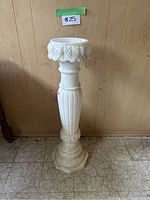 Full view of alabaster pillar stand showing height and overall shape.