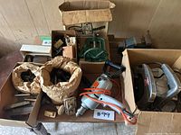 Full overview of all tools and hardware parts included in the lot, showing boxed items and drill with power cord.