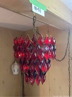 Close-up of red glass diamond-shaped prisms on chandelier