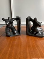 Pair of black stone hand carved woman bookends shown side by side, front angle
