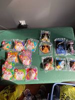 Photo showing all McDonald's Winnie The Pooh Happy Meal toys from 1999 full set and 2001 Book of Pooh series, all sealed in original plastic packaging.