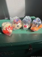 Four Looney Tunes character mugs in original plastic packaging showing front side of Yosemite Sam, Taz, Sylvester, and Daffy Duck mugs