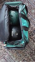 Open carry case showing two bowling balls inside: green swirl ball labeled JMJ8020 Lady and black ball labeled 1N57059 Man.