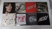 Photo showing eight vinyl record covers including Moxy II, Moxy self-titled, Aerosmith, Triumph, and others.