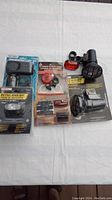 Photo showing the full set of bike accessories including headlight phase kits and flashing lights, some in packaging and some loose.