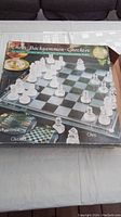 Original box showing branding and contents for chess, backgammon, and checkers 3-in-1 glass set
