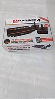 Atari Flashback 4 box showing console and 75 built-in games markings, 40th anniversary special edition