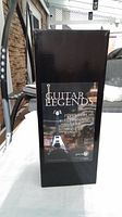 Original black box with Guitar Legends branding and product details including name 'Psychedelic Flying V Guitar Money Bank'.