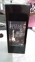 Original box with label showing Fender guitar money bank with stand
