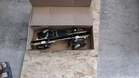 Top view of Tyrolia ski bindings in box on wooden board