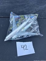 Model airplanes in clear plastic bag showing Air Canada and other planes