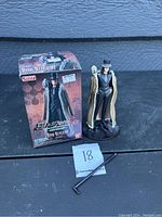Photo of Rob Lucci action figure next to its original box on a black surface, with item's number tag visible.