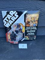Photo of Star Wars 30th Anniversary Coin Album with attached Darth Vader figure and collectible coin in original packaging.