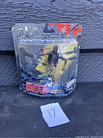Photo of The Walking Dead Zombie Roamer action figure in original packaging showing front view and label.